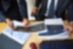 investor-trader-discussing-statistic-data-holding-papers-with-financial-charts-pen-cropped